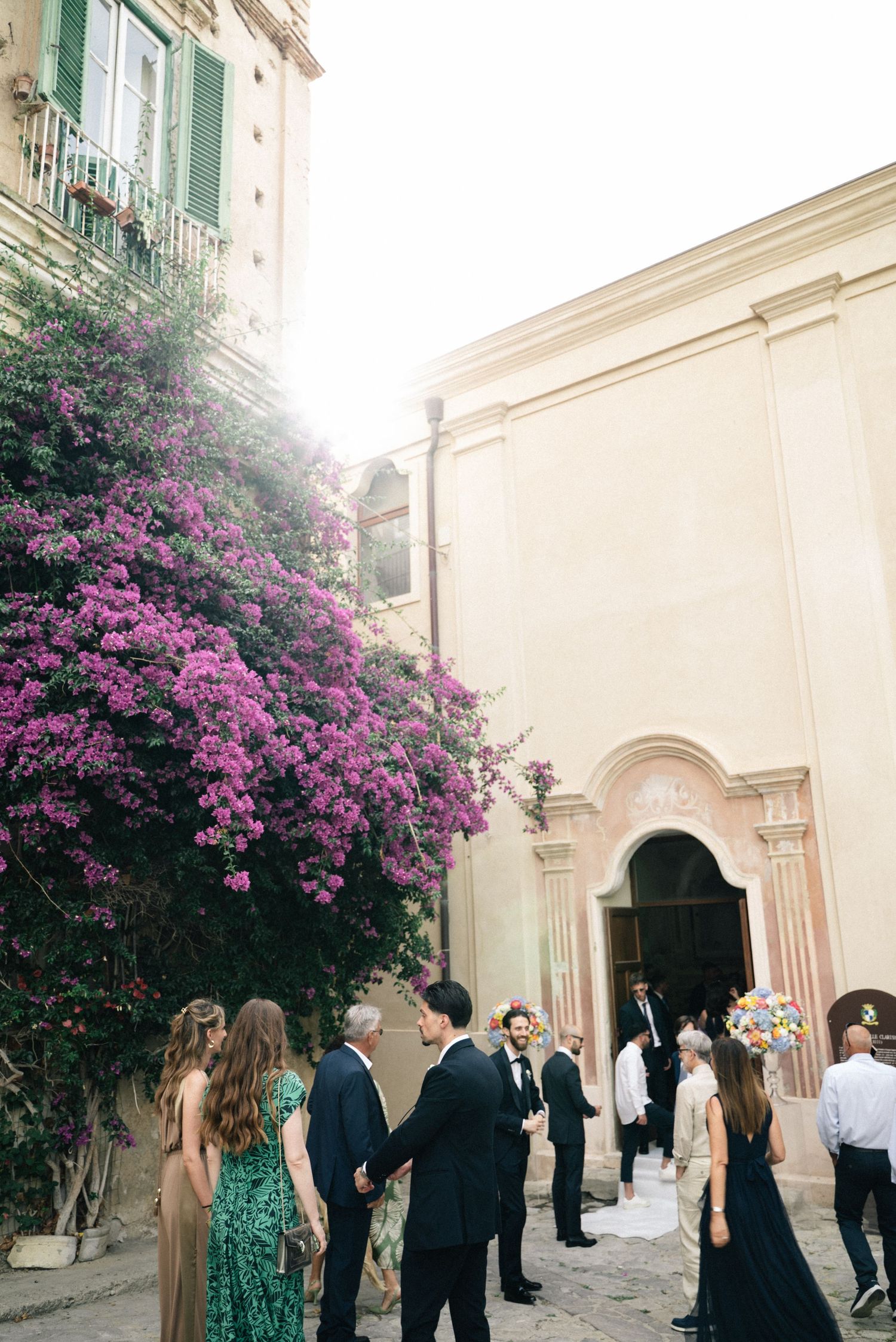 Wedding guests outside the ceremony venue in Tropea historic centre