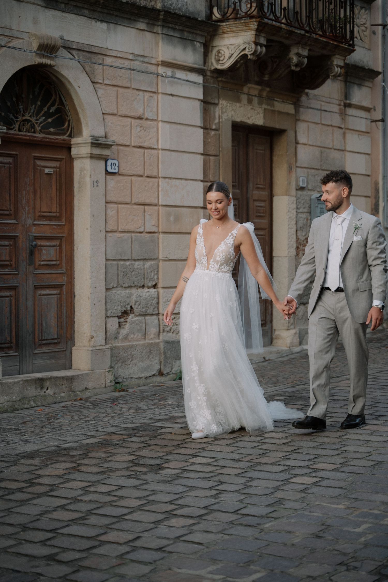 Bride and groom walking through the historic streets after their wedding