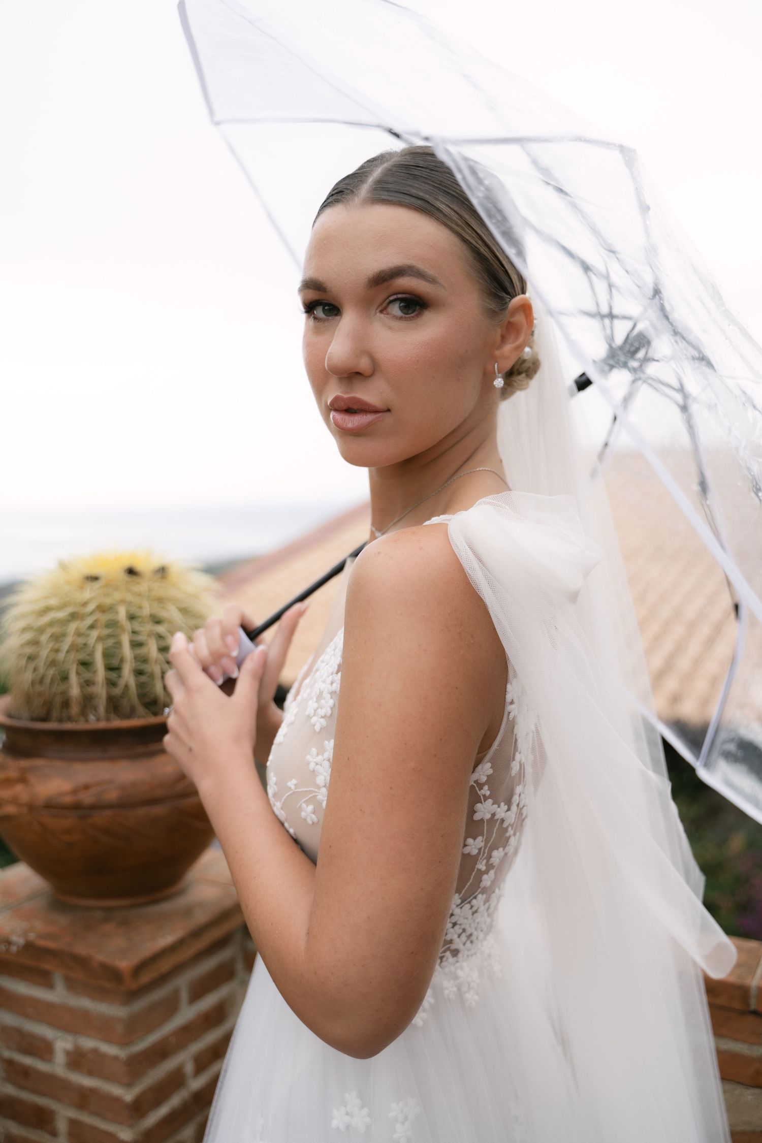 Bridal portrait beneath a transparent umbrella in Sicily