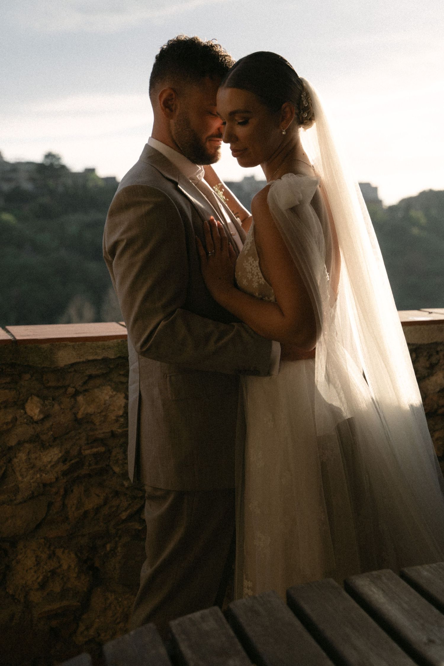 Bride and groom at sunset overlooking the Sicilian landscape