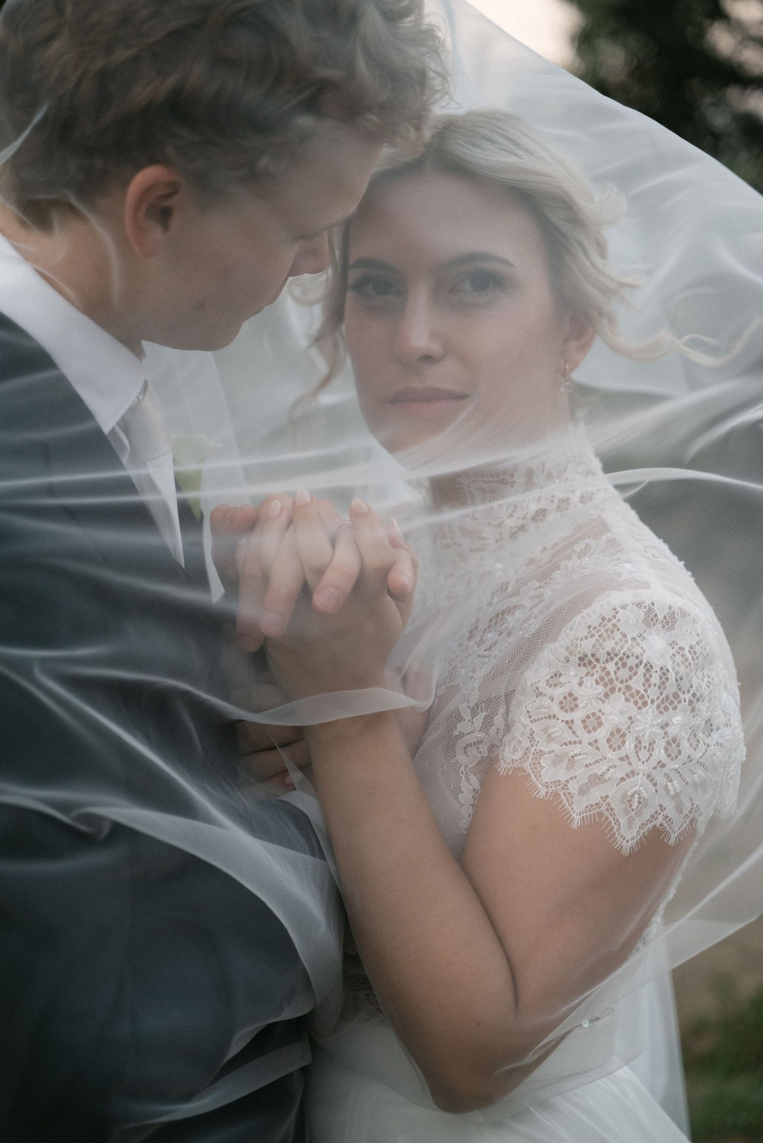 Serena and Paul surrounded by the bride's flowing veil