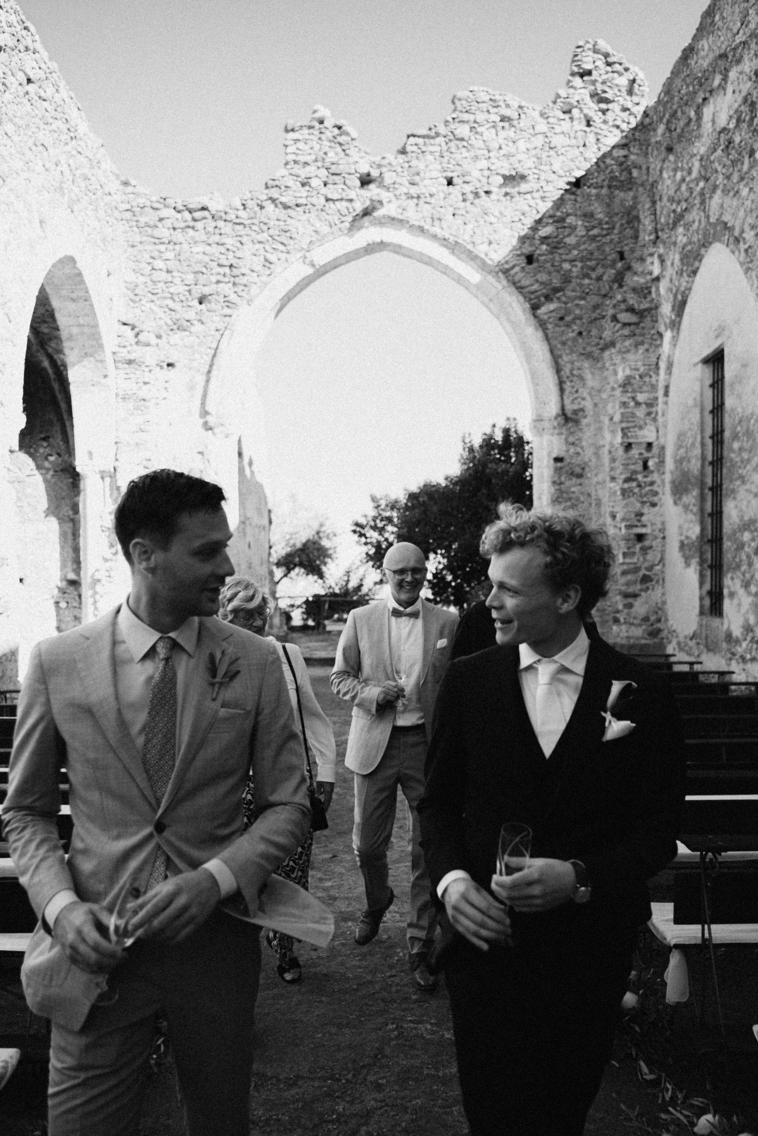 Groom walking with guests before the ceremony at Borgo del Convento