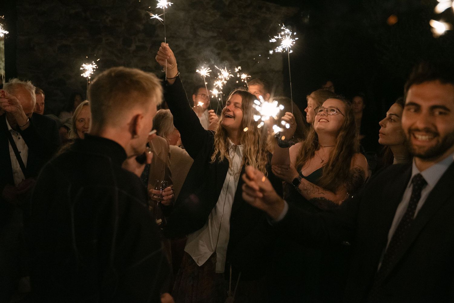 Wedding guests celebrating with sparklers in Calabria