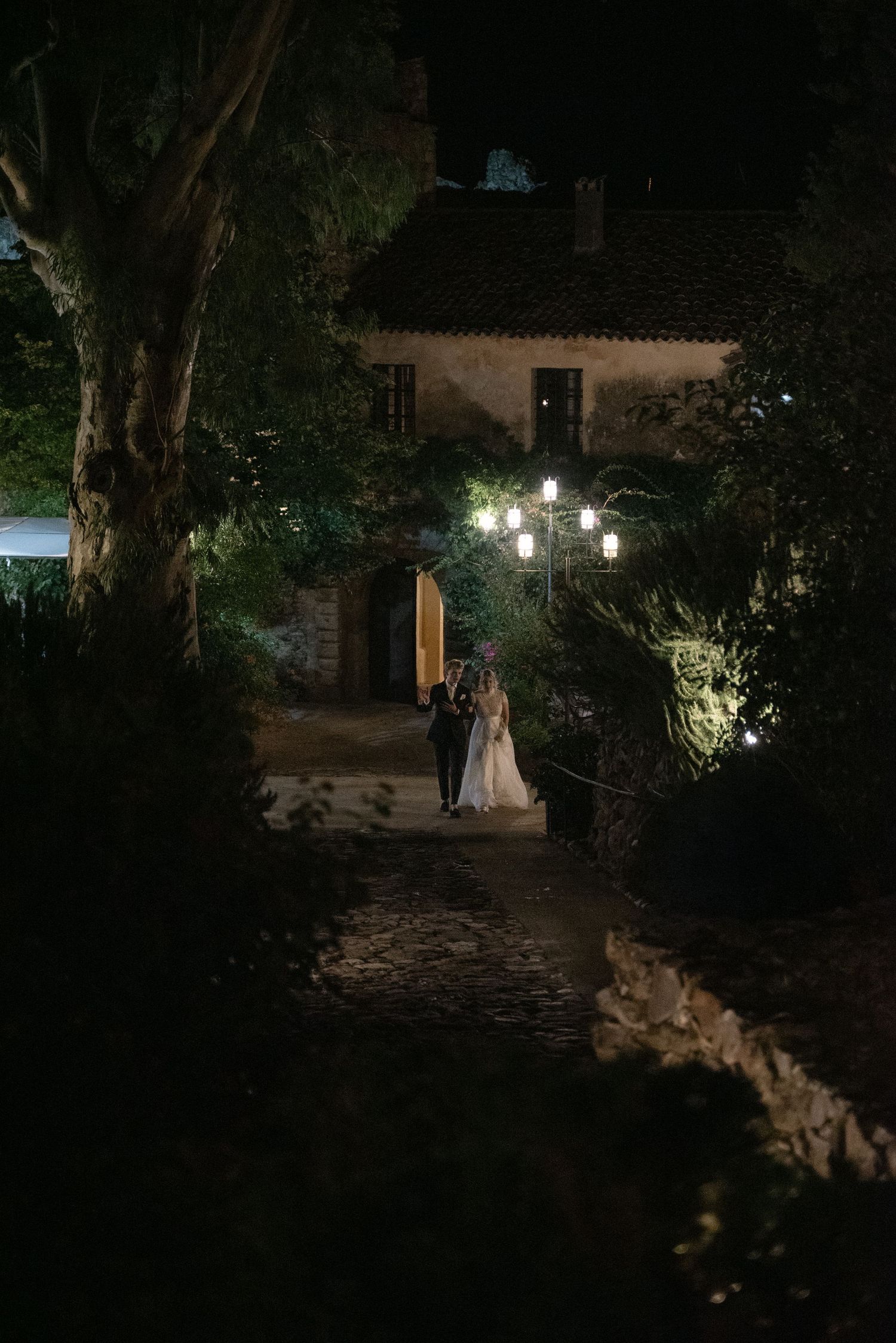 Serena and Paul walking together through Borgo del Convento at night