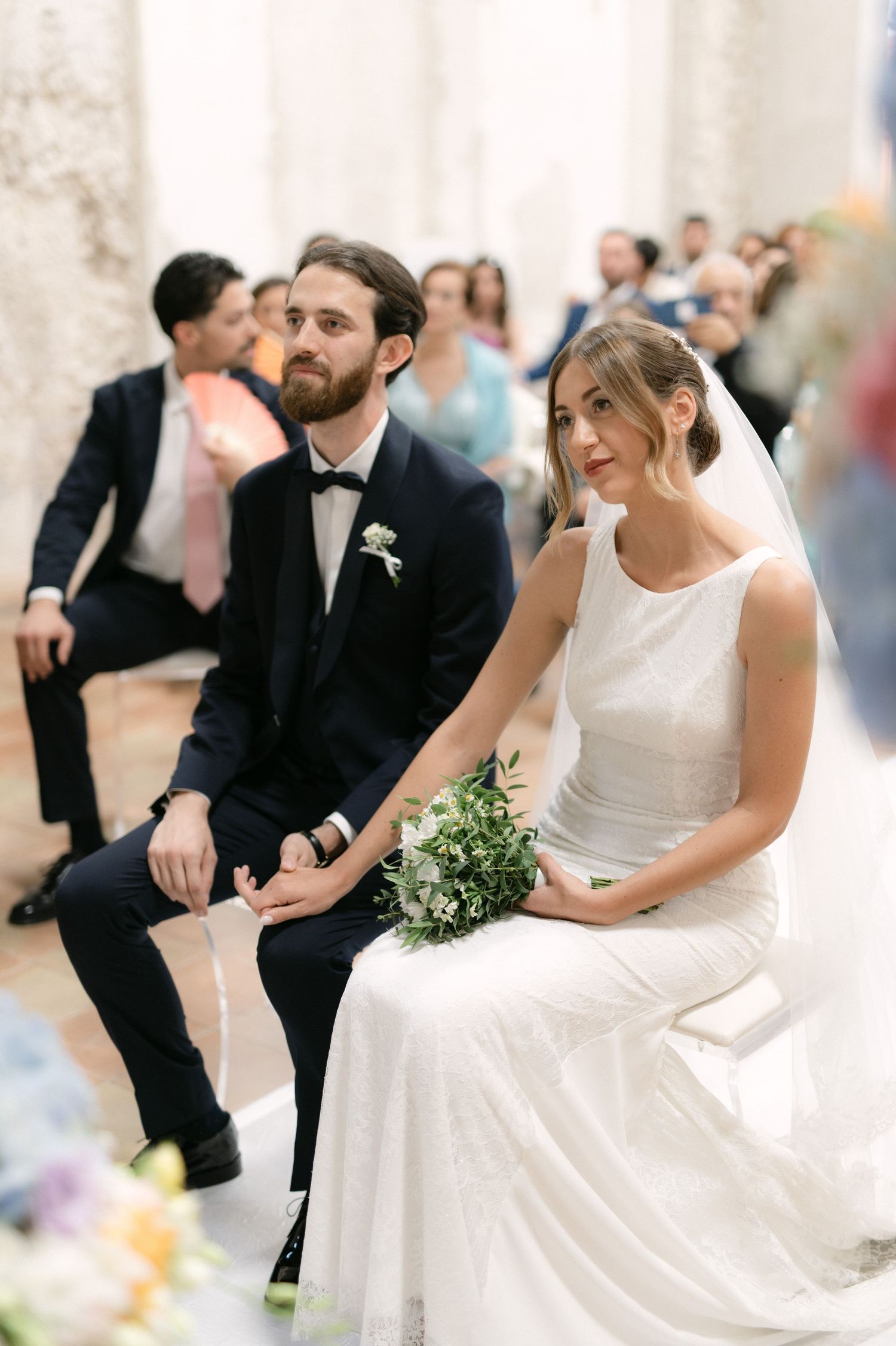 Bride and groom holding hands during the ceremony in Tropea