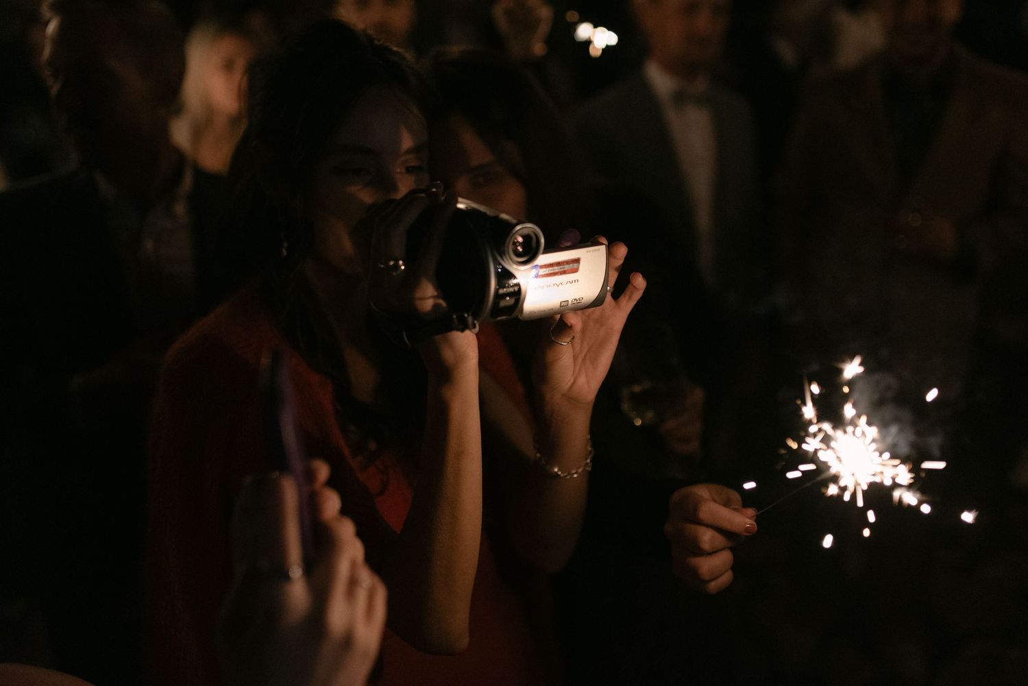 Guest filming the wedding celebration with a vintage camcorder