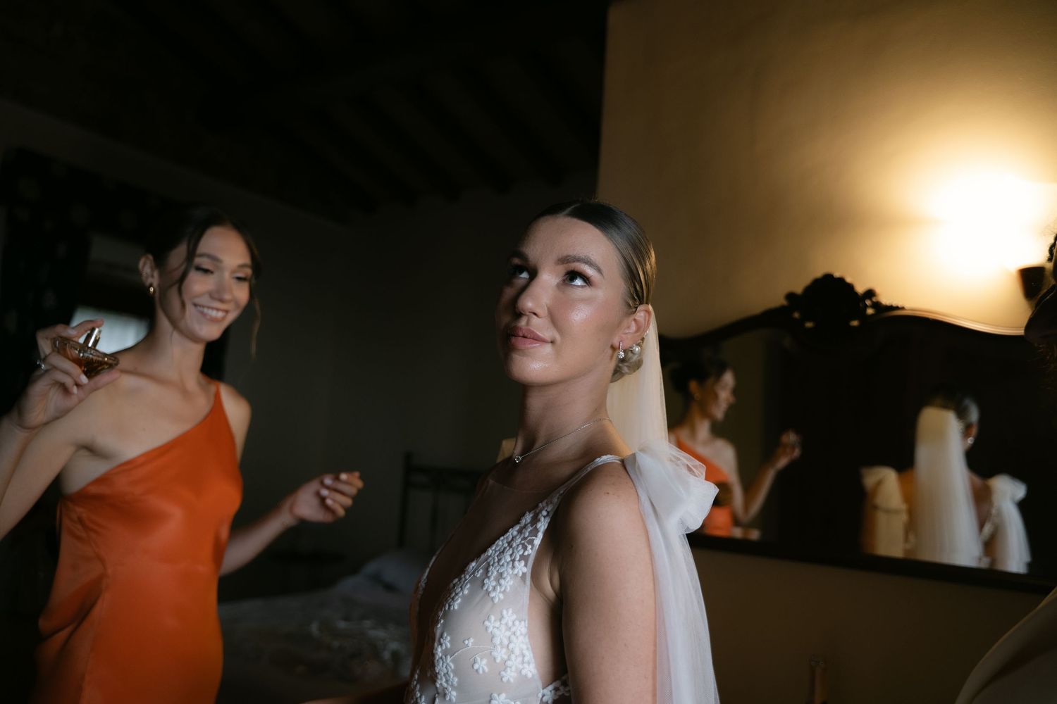 Bride sharing a moment with a bridesmaid before the ceremony