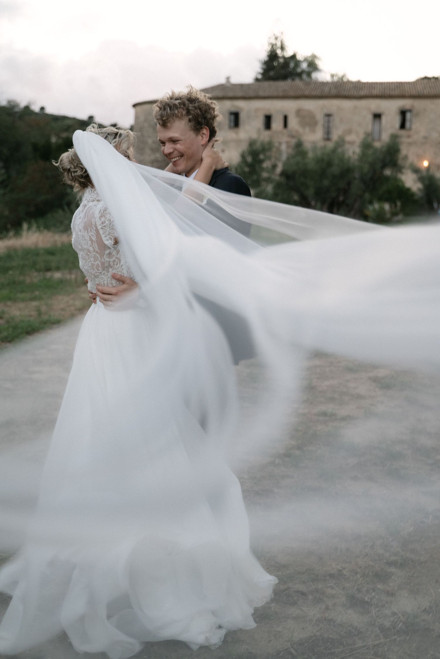 Wedding portrait with the bride's veil moving in the wind
