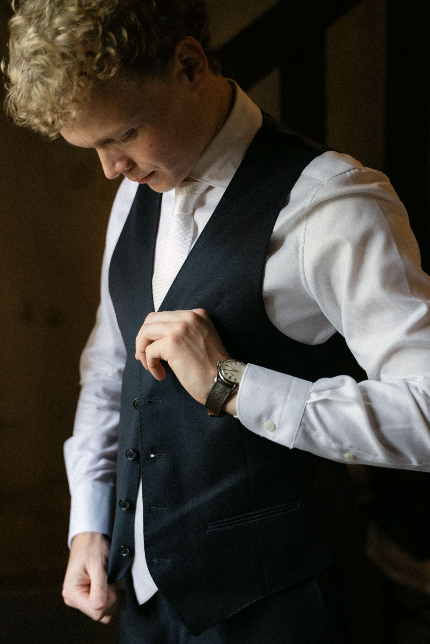 Groom dressed in a black suit before the ceremony
