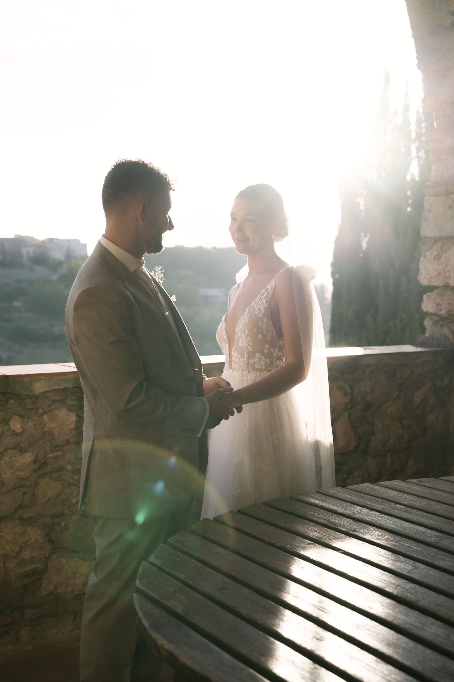 Newlyweds holding hands during sunset portraits in Sicily