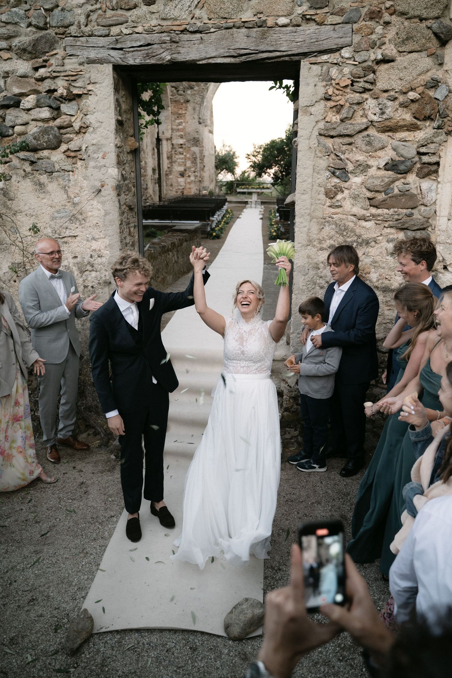 Serena and Paul celebrating as they leave their wedding ceremony