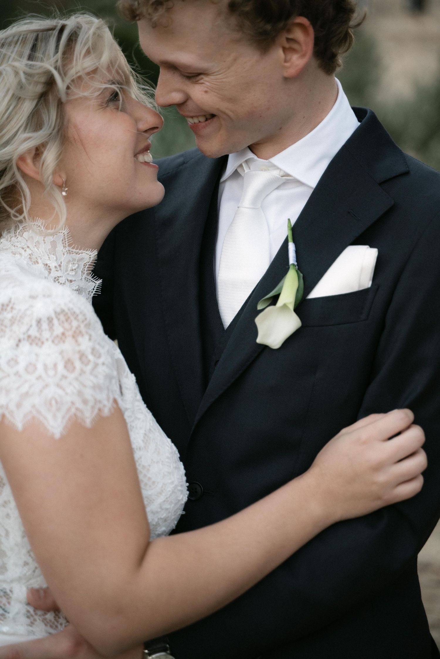 Close-up portrait of the newlyweds smiling together