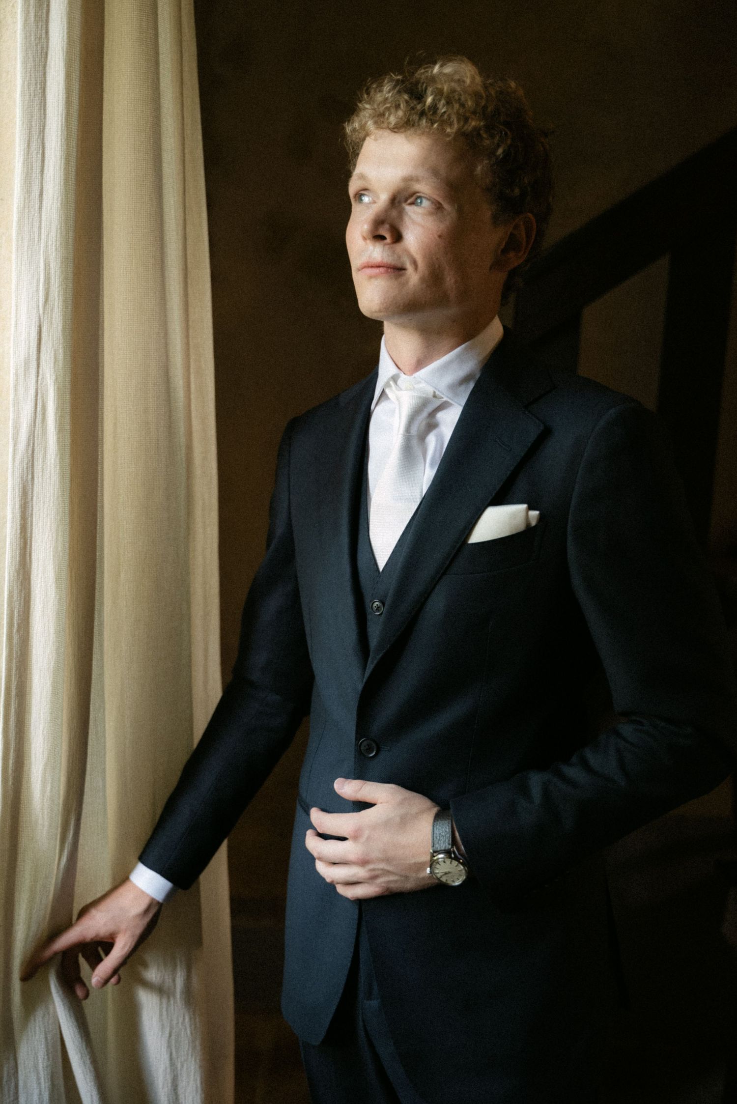 Groom portrait beside a window at Borgo del Convento