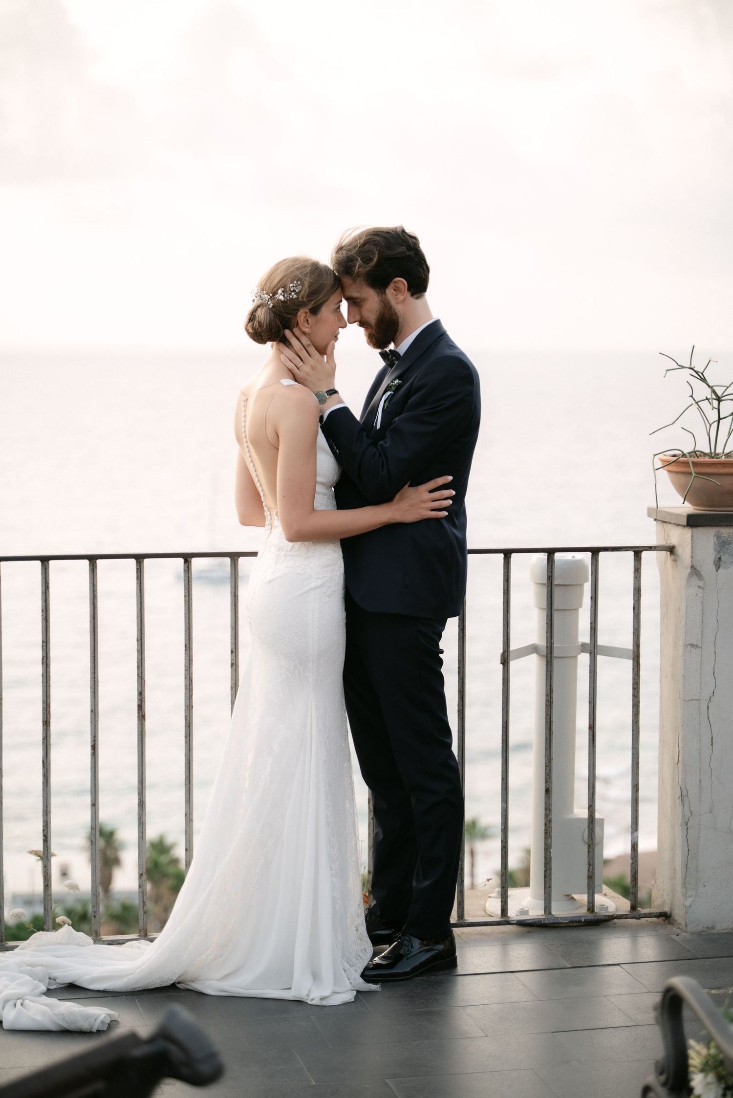 Bride and groom sharing a quiet moment overlooking the Mediterranean
