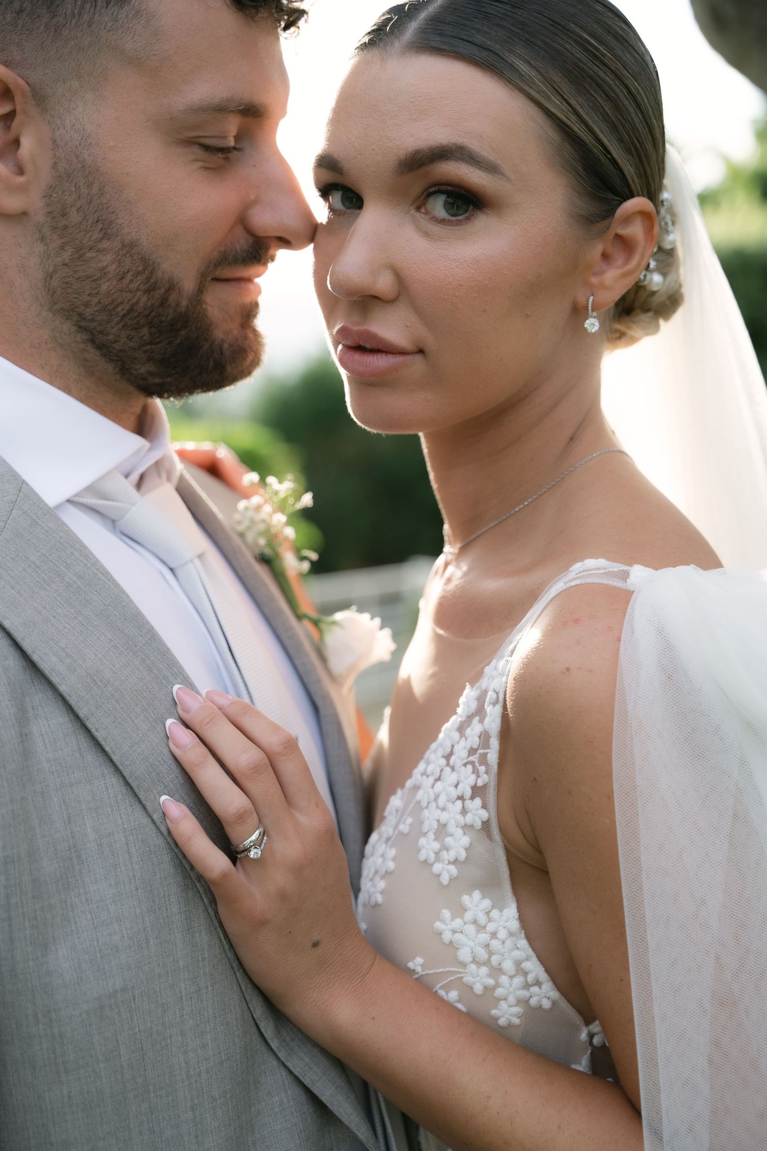 Close-up wedding portrait of the bride beside the groom