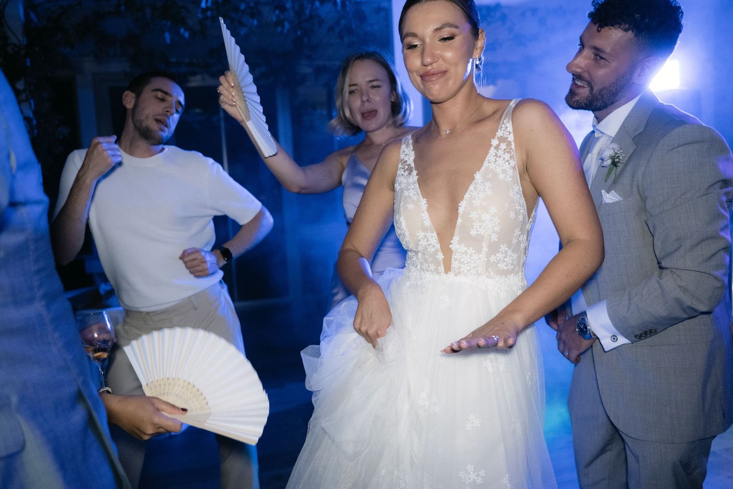 Bride and groom celebrating with guests on the wedding dance floor
