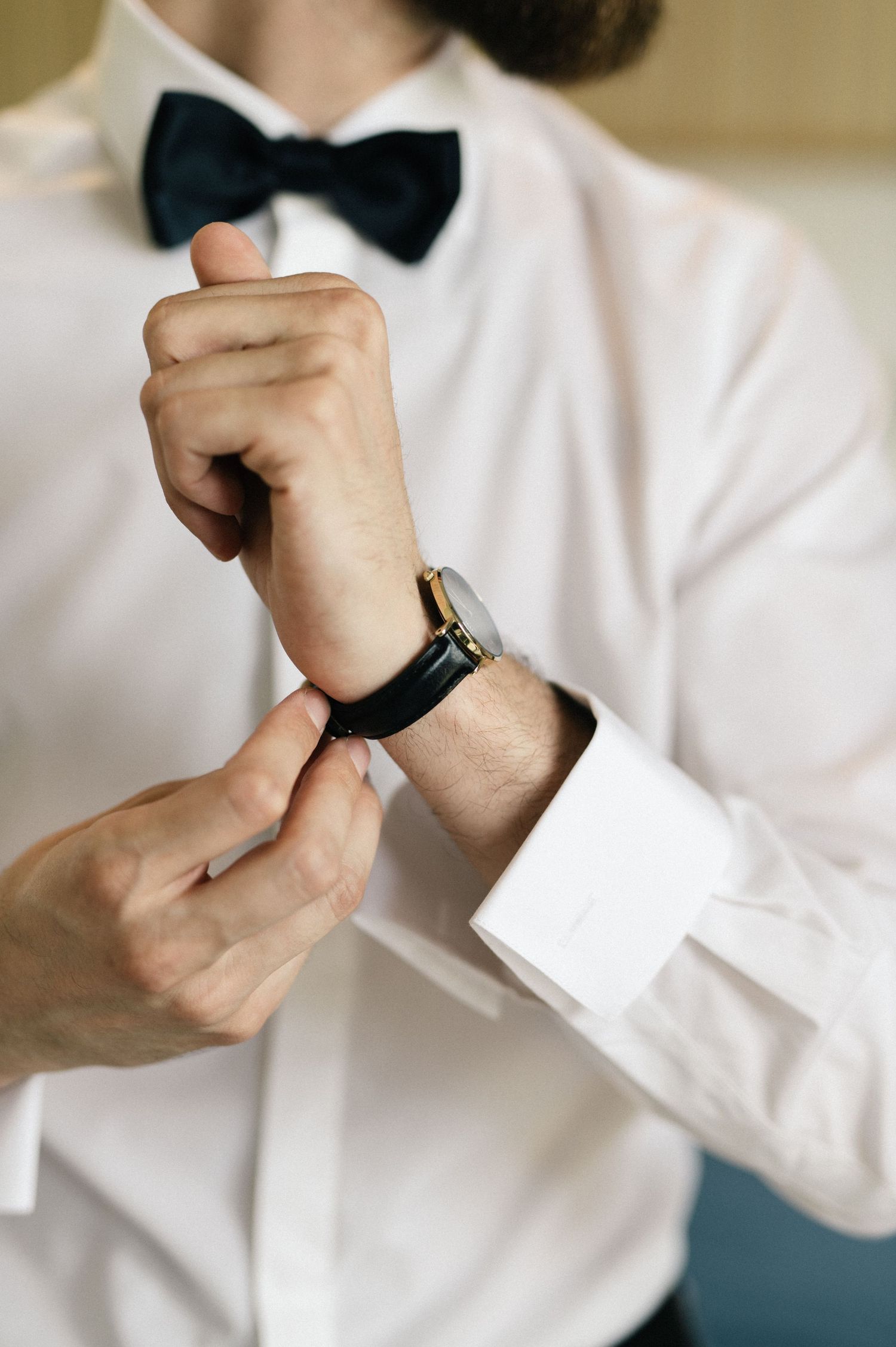 Groom adjusting his watch before the wedding ceremony