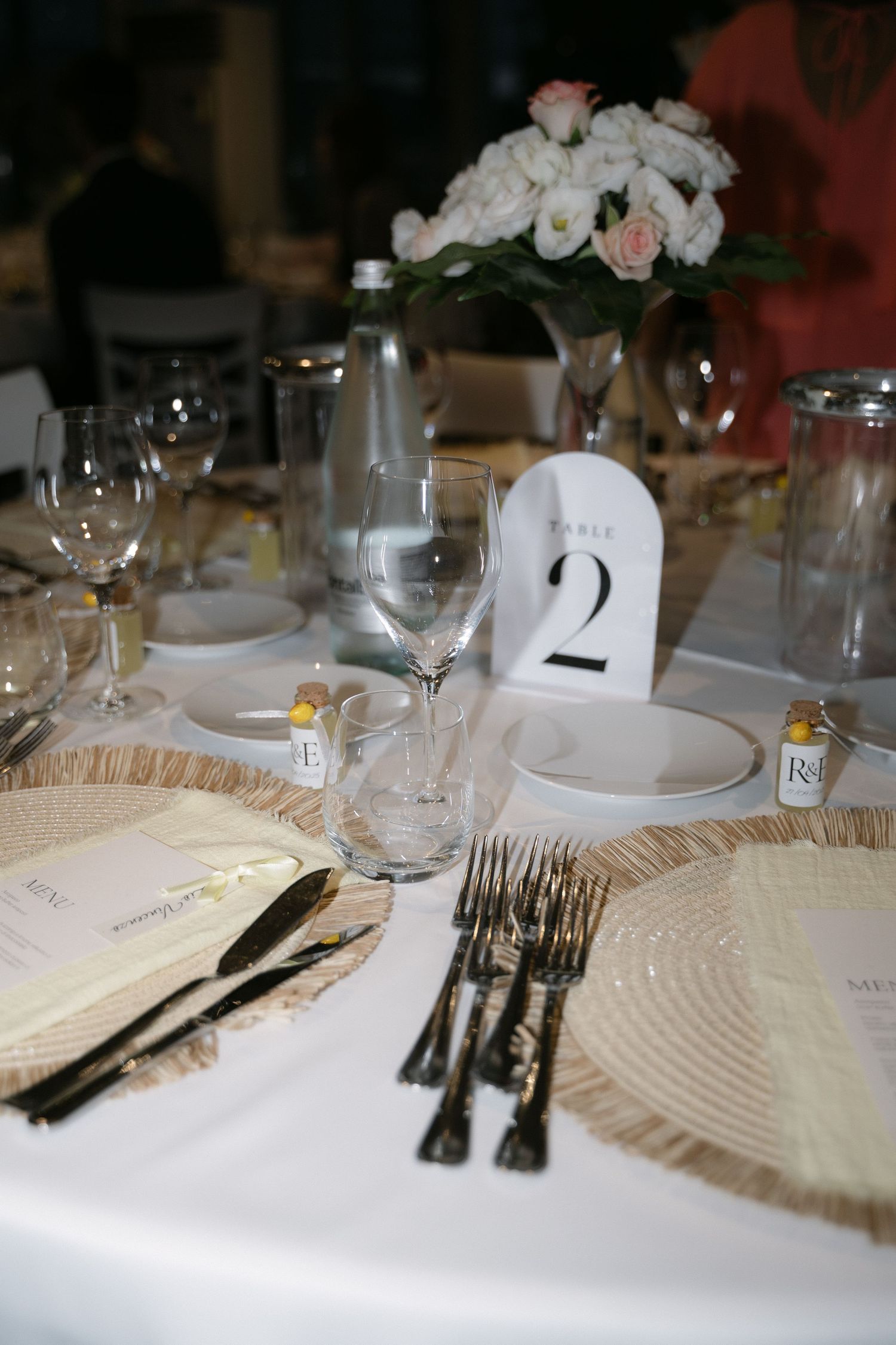 Wedding table setting with flowers and personalized details
