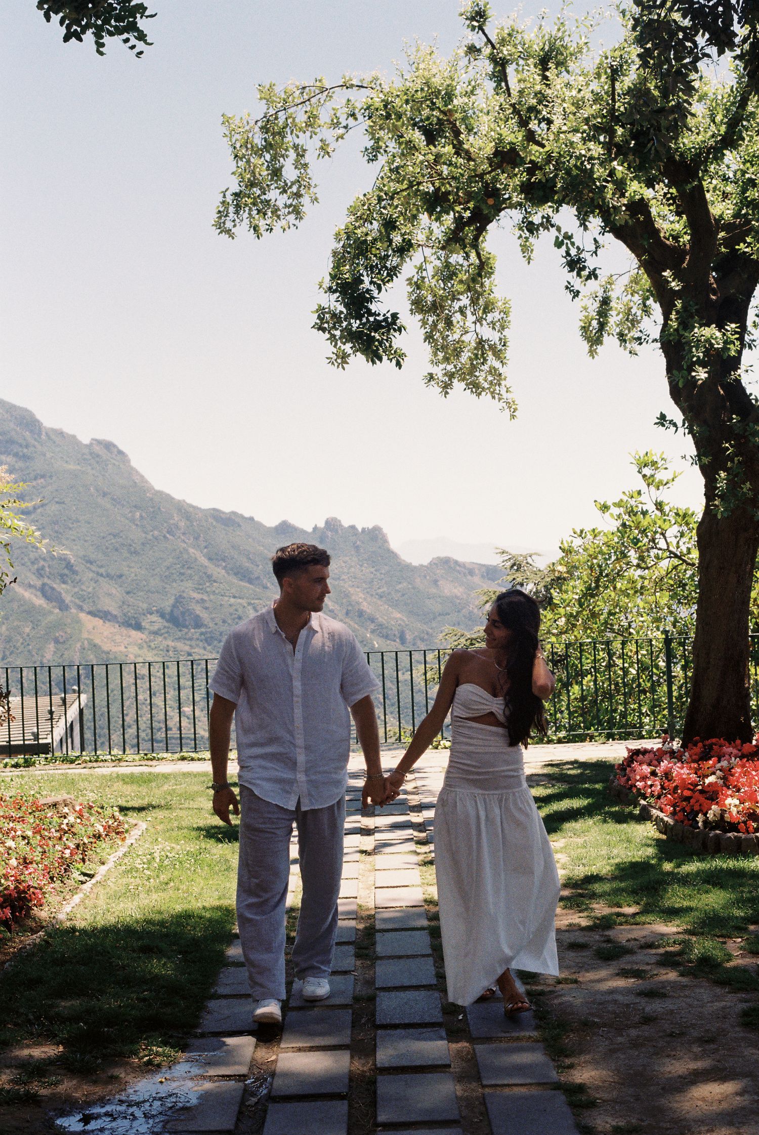 Couple walking through a Ravello garden after their proposal