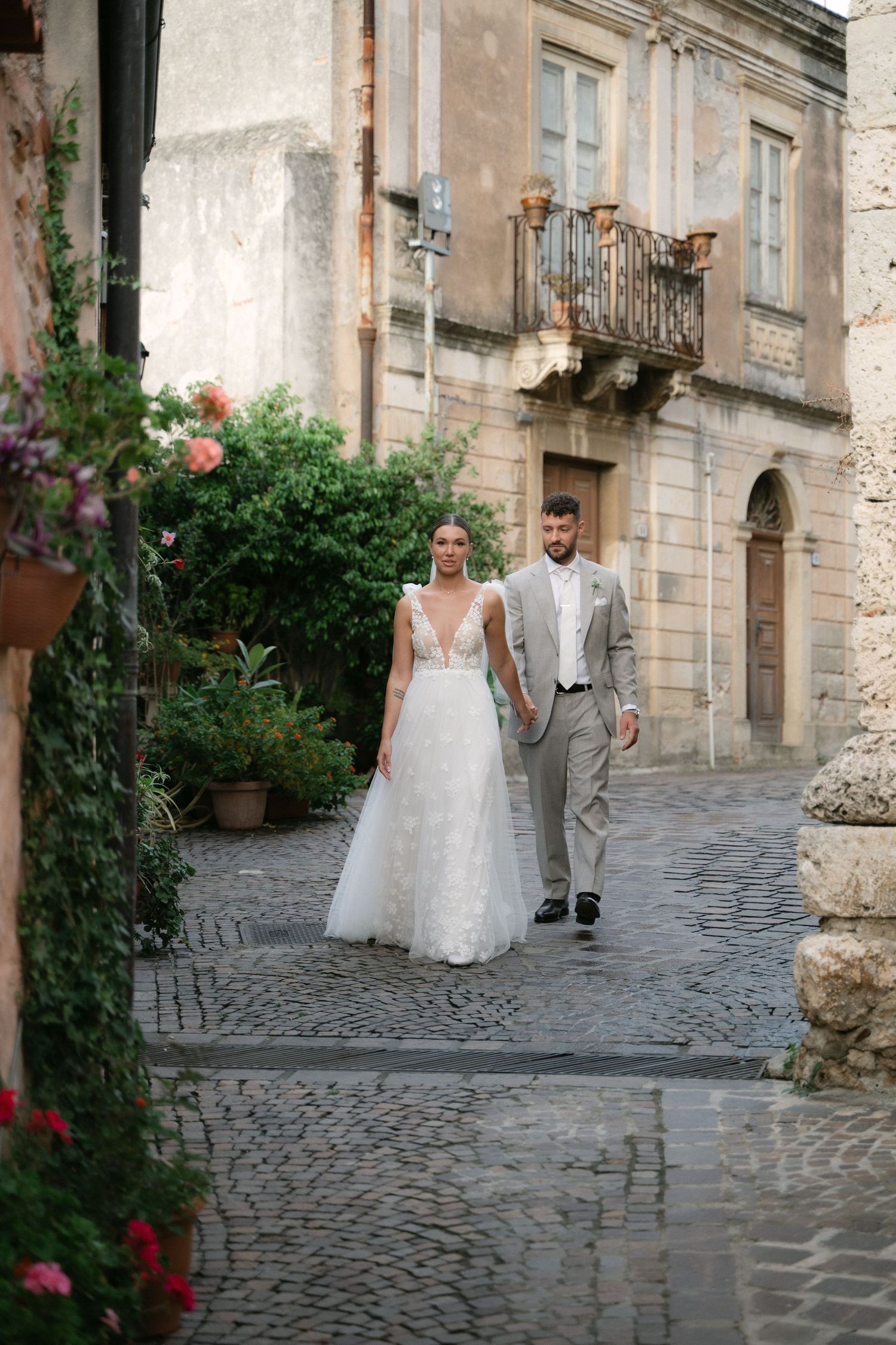 Wedding portrait of the couple on a cobblestone street in Sicily