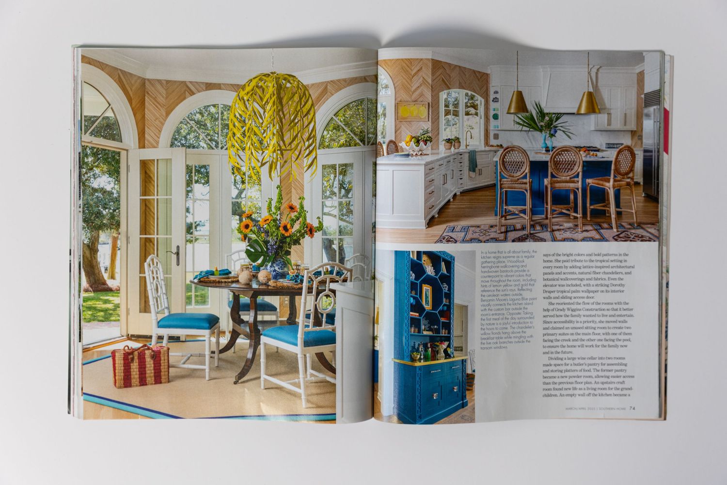 Magazine layout showing elegant home interior with arched windows and blue accent furniture.