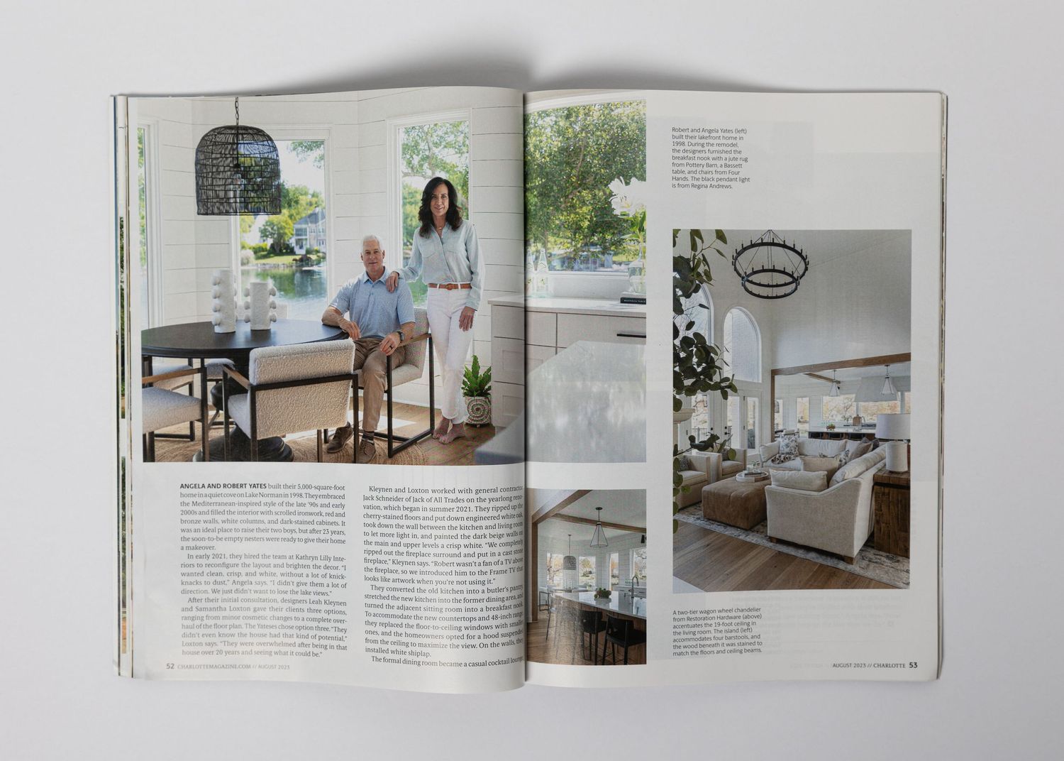 Magazine spread showcasing bright white kitchen design with counter seating and living room spaces.