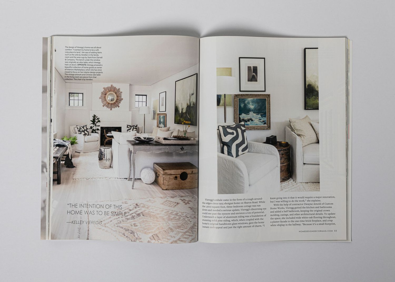 Magazine spread displaying minimalist living room interior with neutral tones and artistic decor.