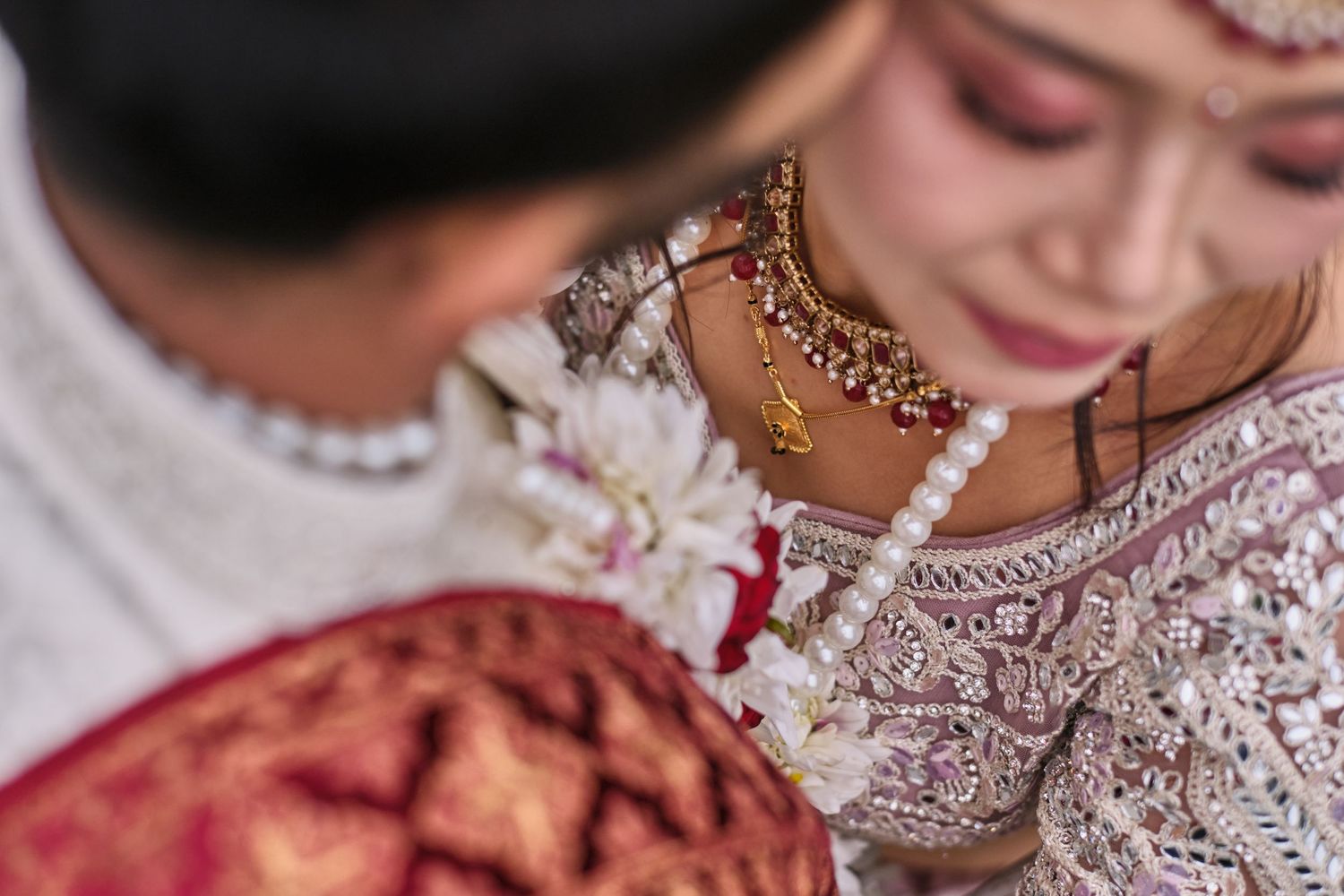 Close-up details of traditional Indian bridal jewelry and accessories in gold.