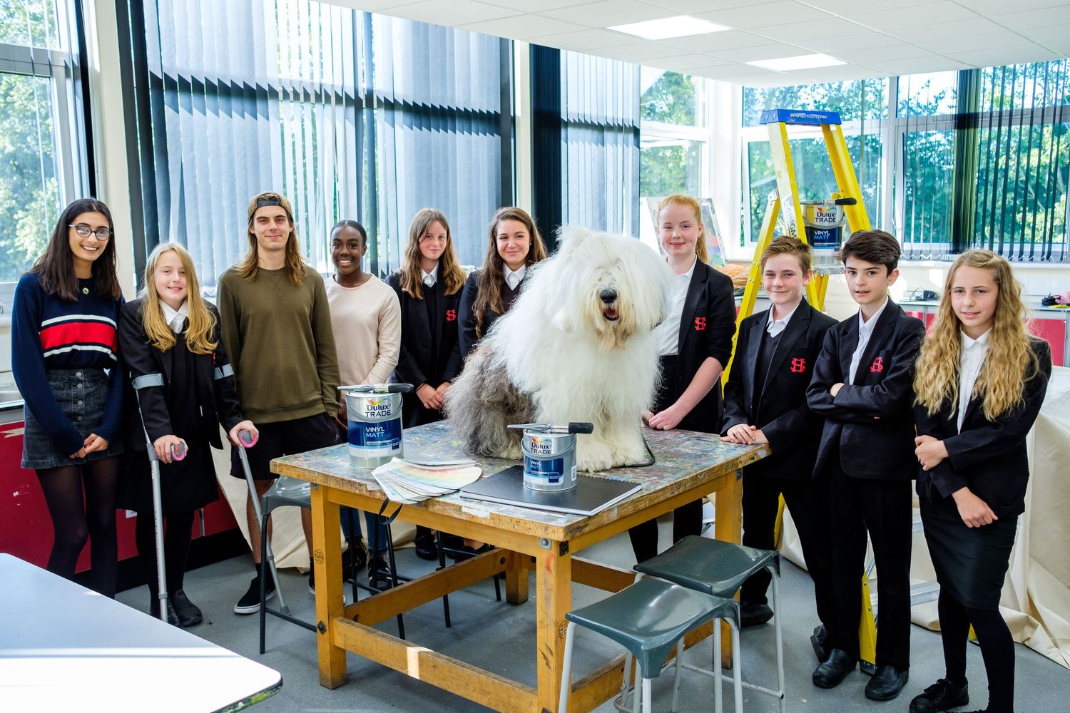 Group of students engaged in practical education activities in a bright modern classroom setting.
