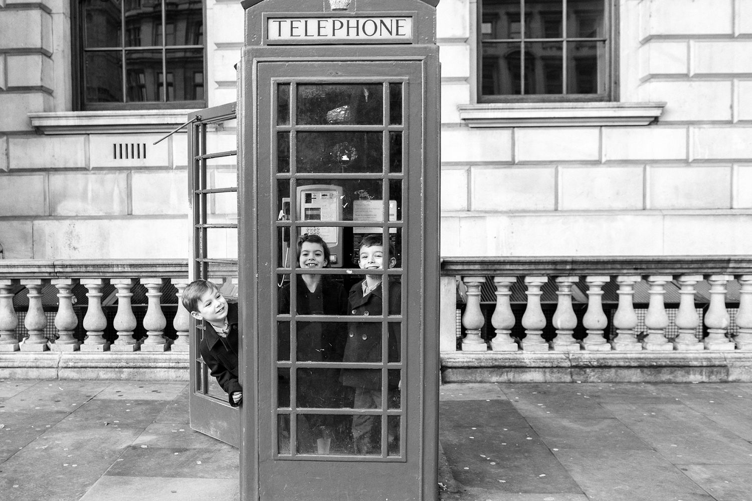 Architectural sequence showing vintage telephone booth and windows with classic balustrade details.