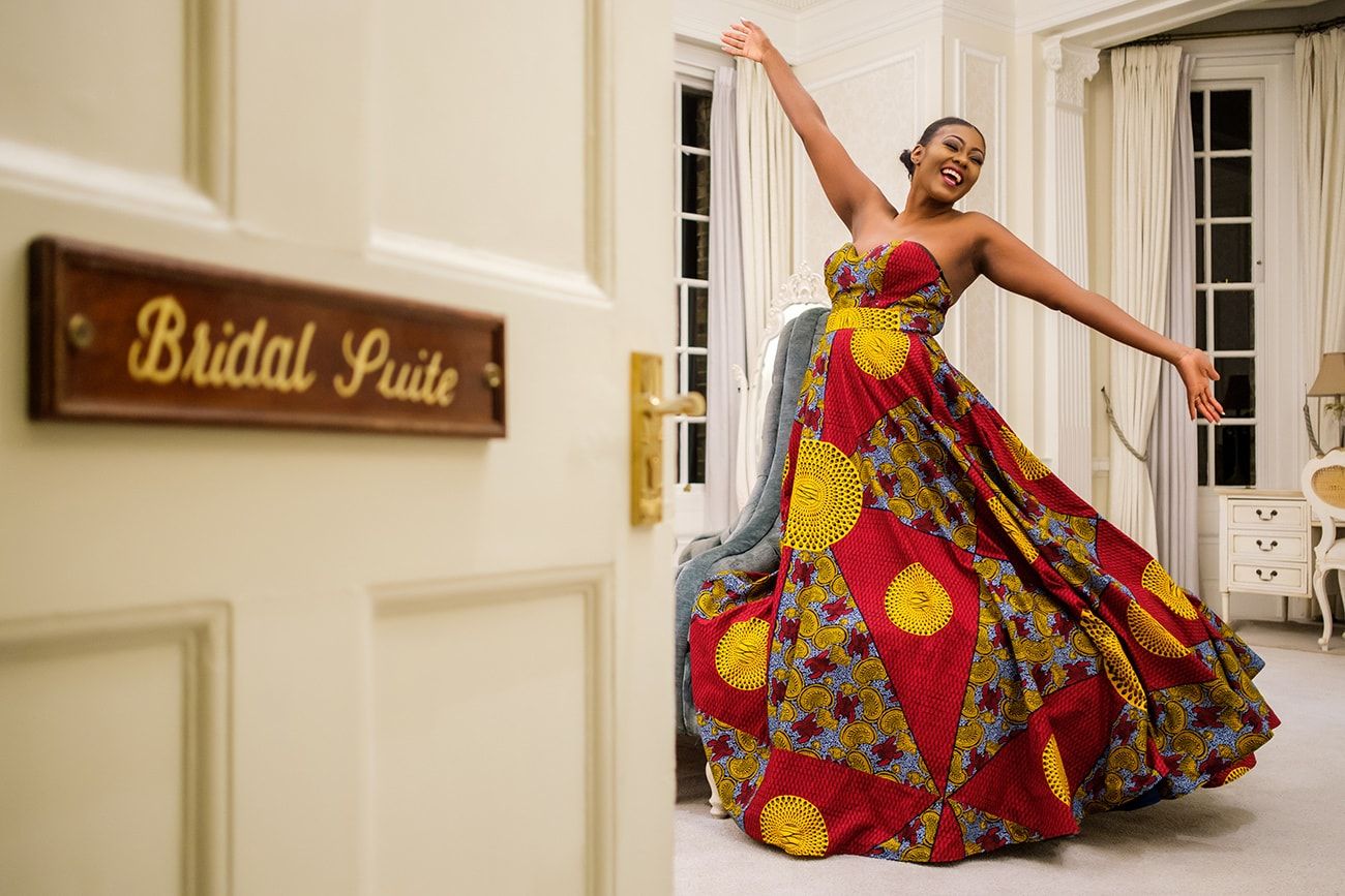 Dynamic dance performance in vibrant traditional costumes within an elegant venue.
