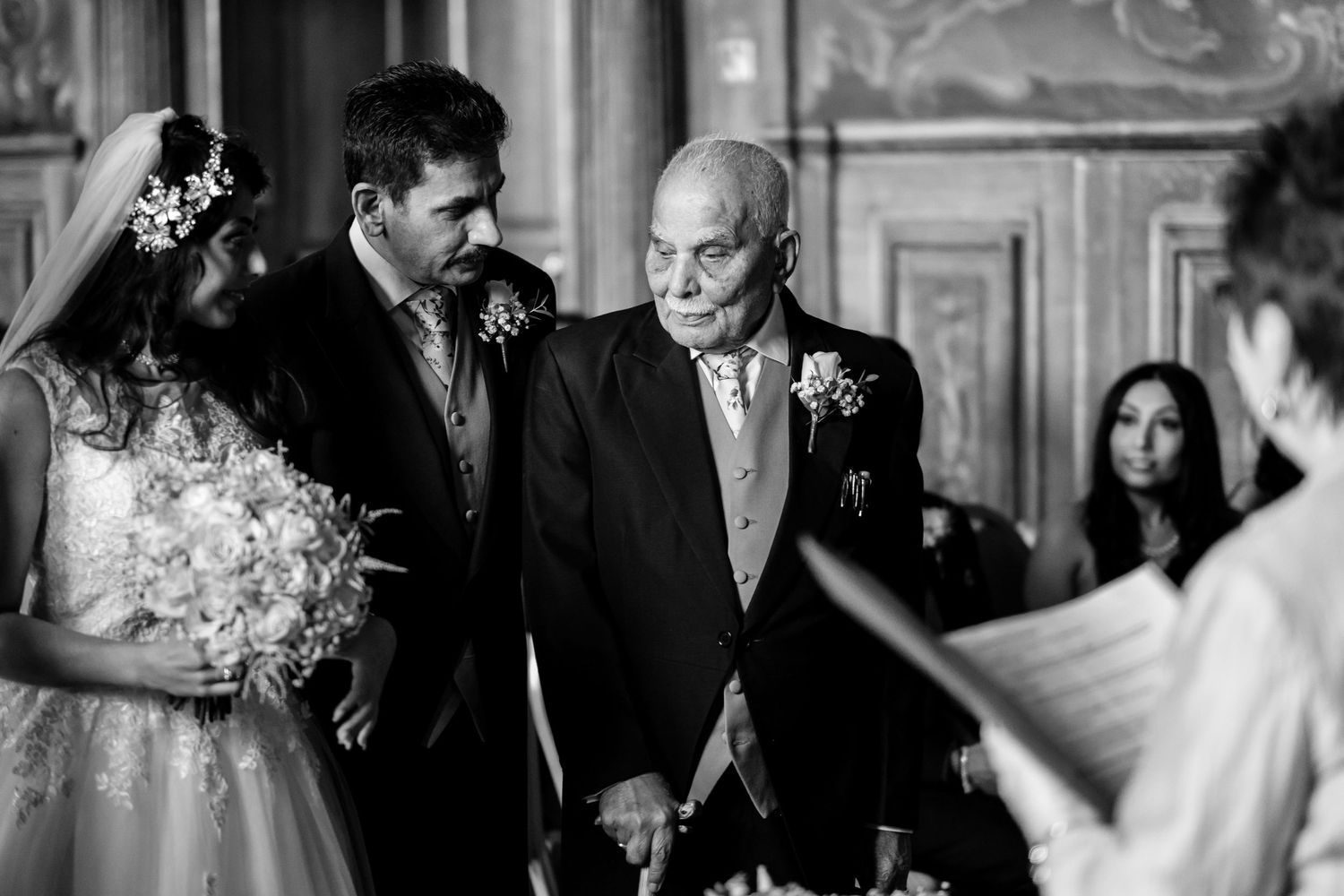 Candid wedding ceremony moments captured in a grand historic venue.