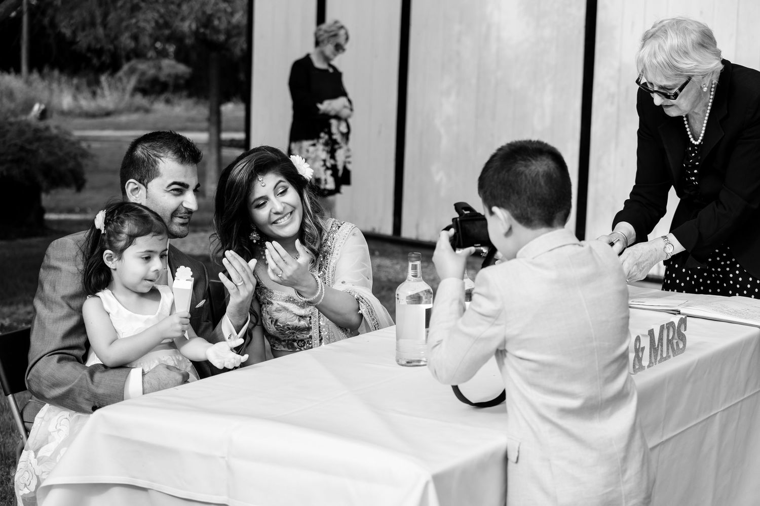 Black and white reception scenes showing guests at dining tables.