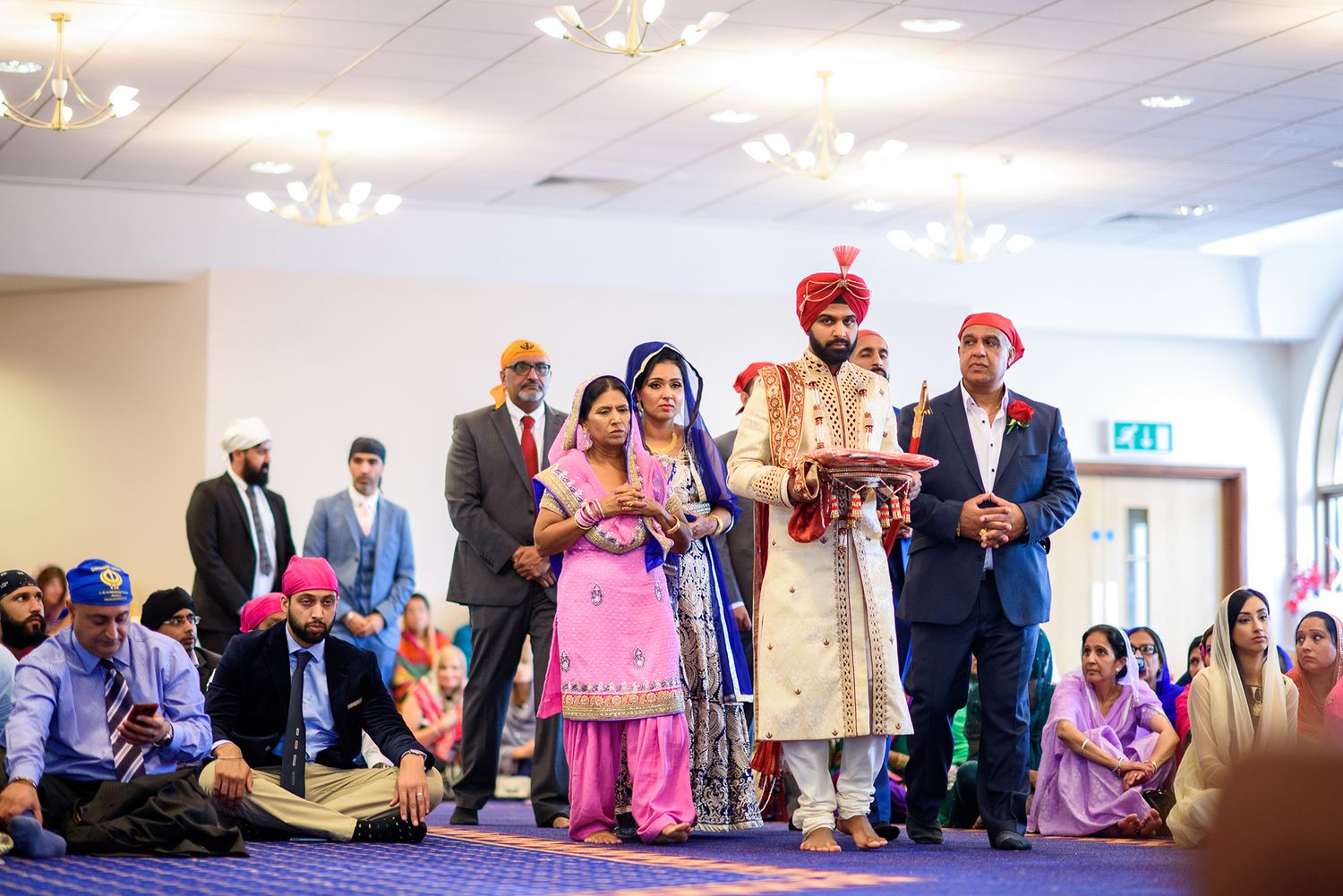 Wedding celebration in a bright indoor venue with traditional decor.