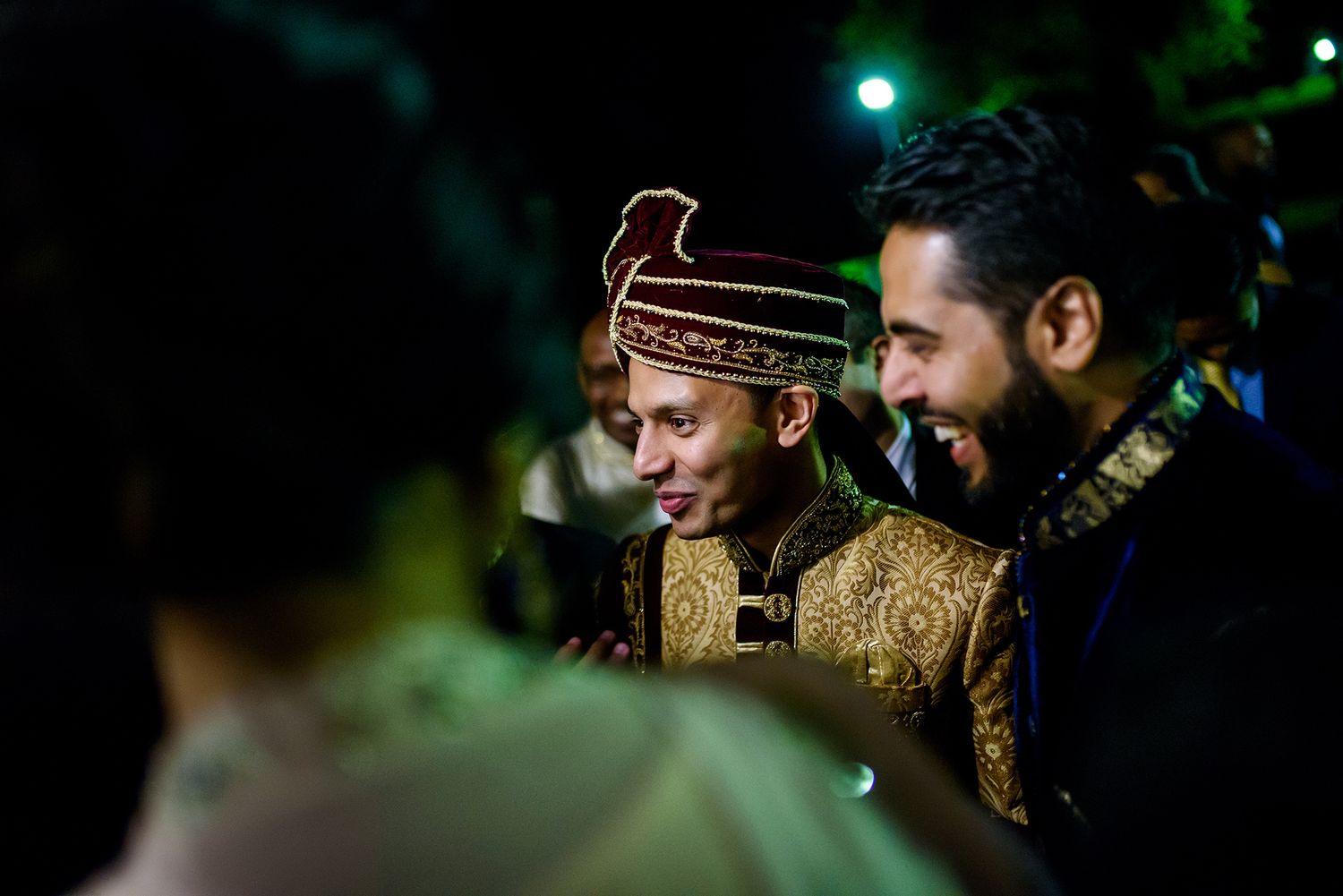 Nighttime celebration with traditional formal attire and festive lighting.