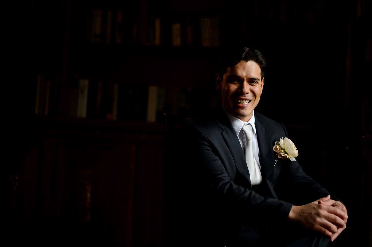 Artistic wedding portraits captured in dramatic low-light setting.