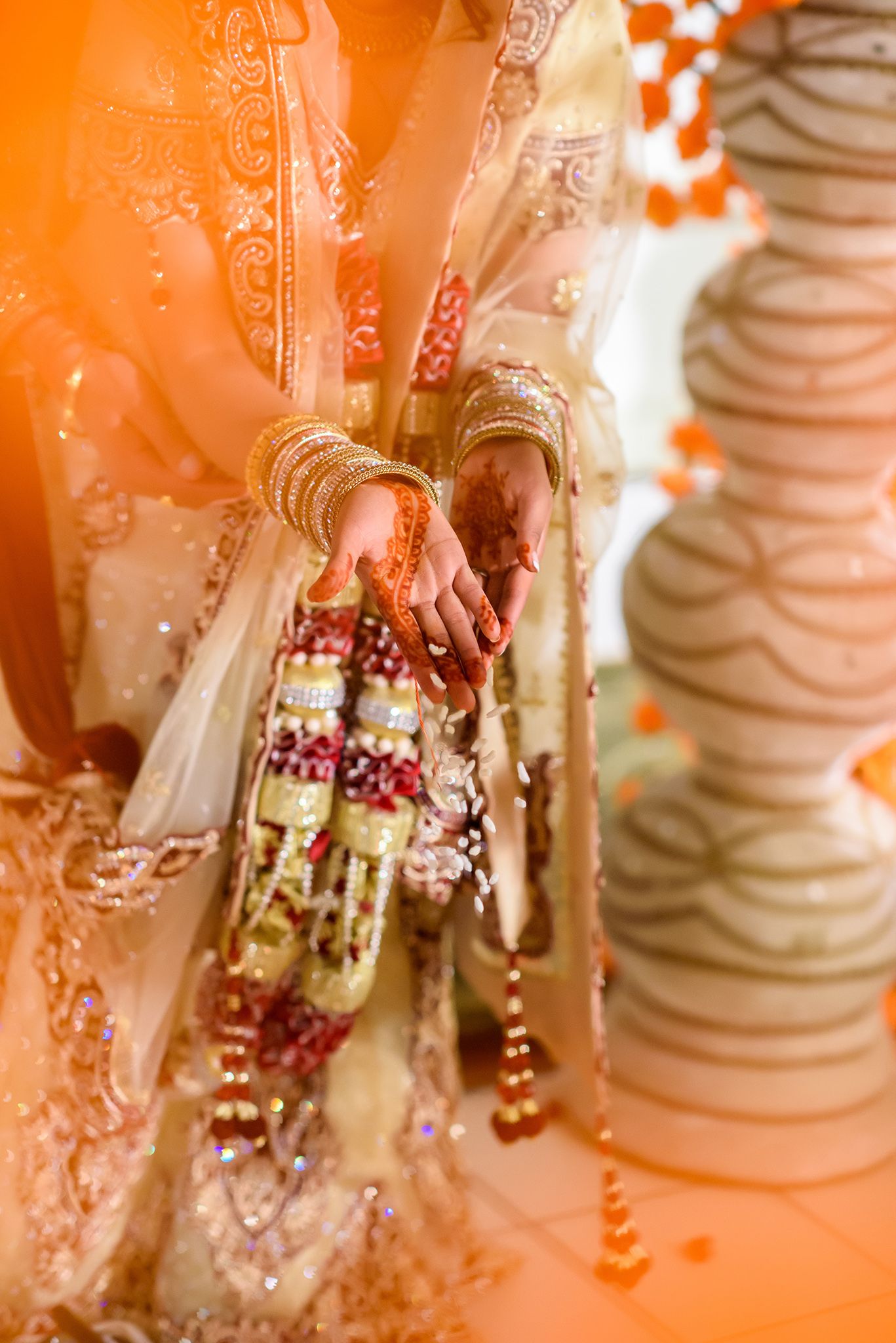 Detail shots of traditional Indian bridal jewelry and wedding attire in warm lighting.
