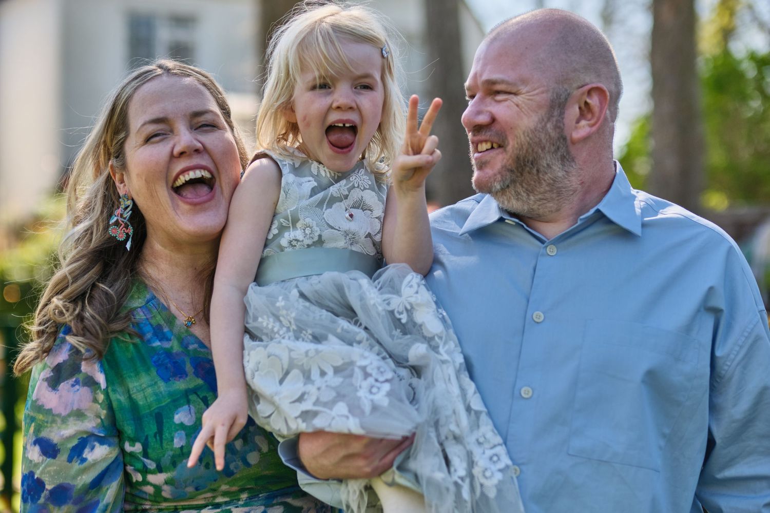 Candid celebration moment with guests laughing and enjoying outdoor festivities.