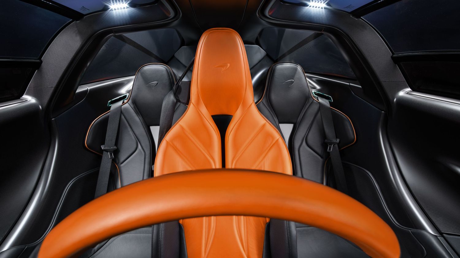 Interior cockpit shot of a McLaren supercar showing its driver-focused dashboard and controls.
