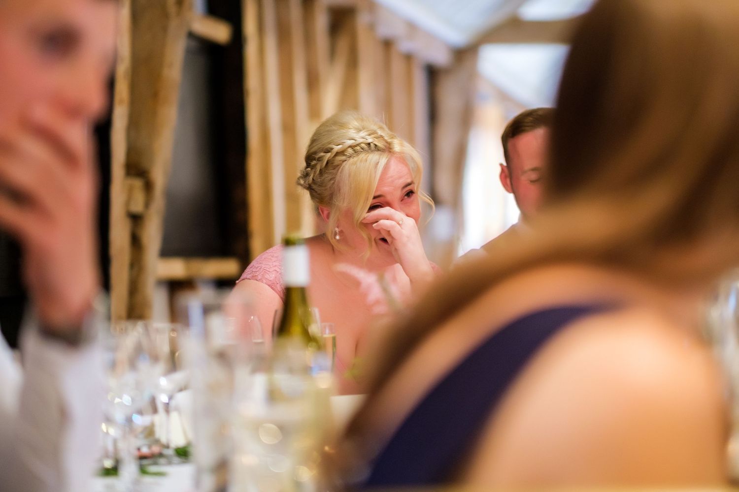 Candid moments captured during wedding reception dinner conversations.