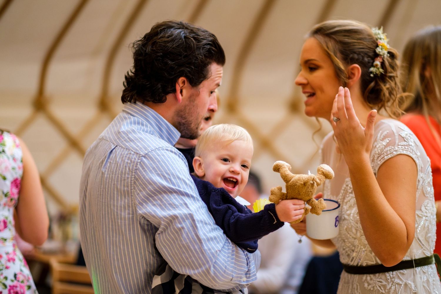 Candid reception moments showing guests laughing and celebrating at wedding tables.