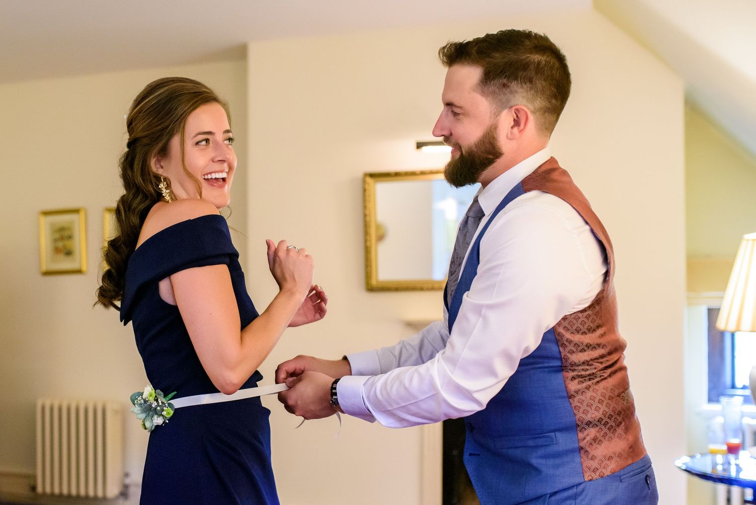 Couple dancing and laughing together during a celebration.