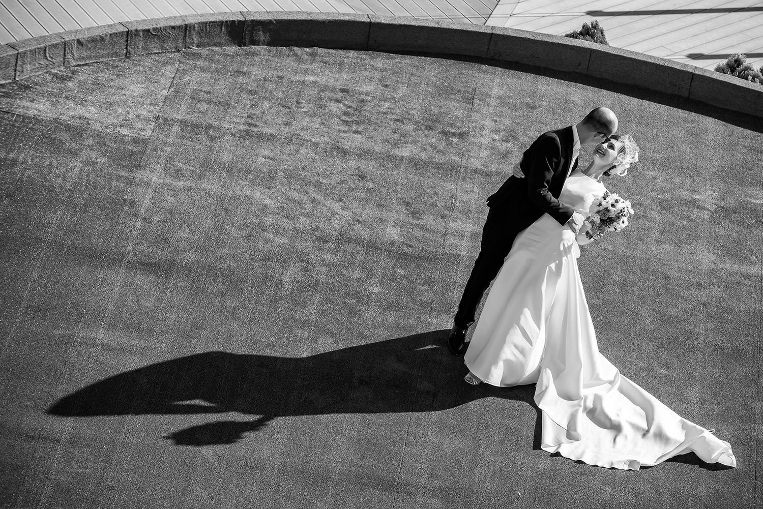 Black and white wedding photography capturing dramatic shadows on an outdoor terrace.