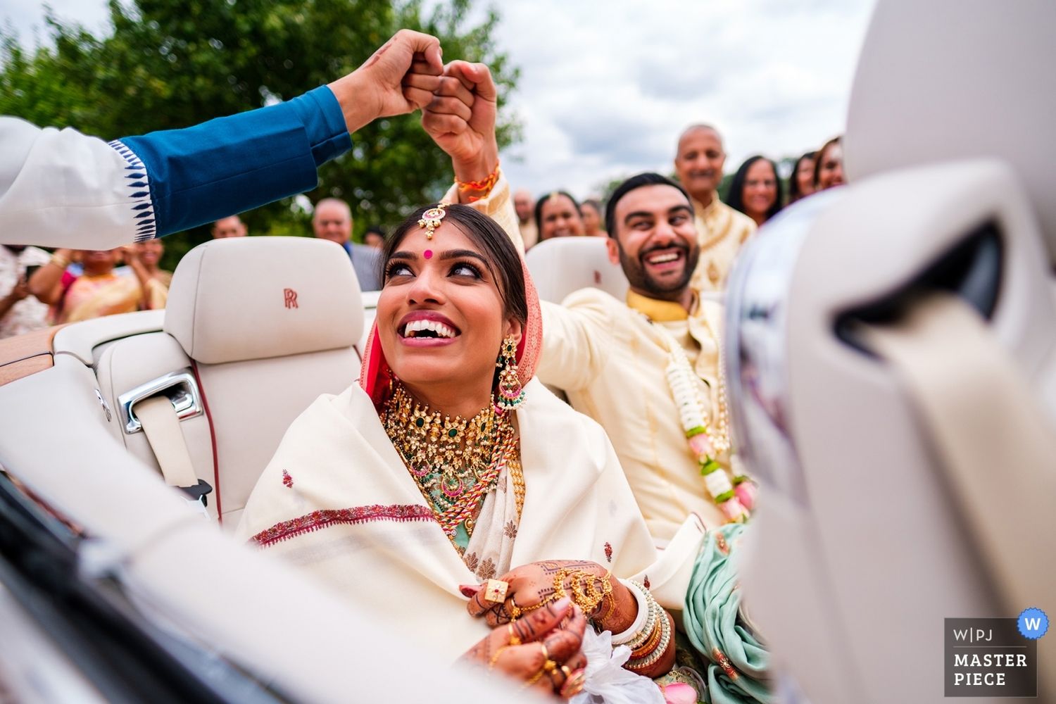 Joyful celebration with festive decor and guests gathered at an outdoor wedding event.