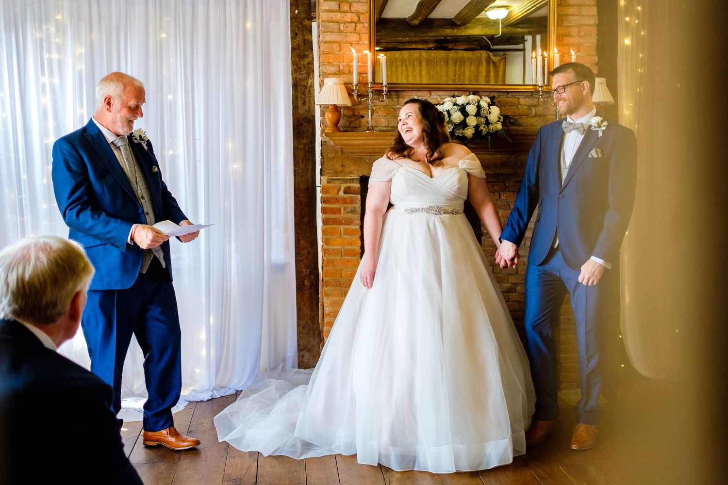 A series of candid wedding moments showing interactions between people in a rustic brick-walled venue.