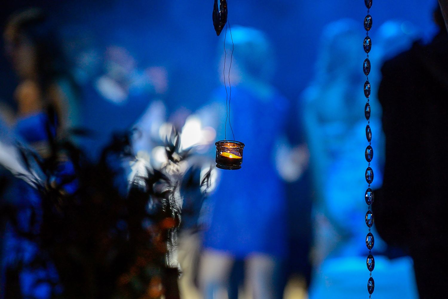 Artistic detail of decorative elements with blue bokeh lighting effects in background.