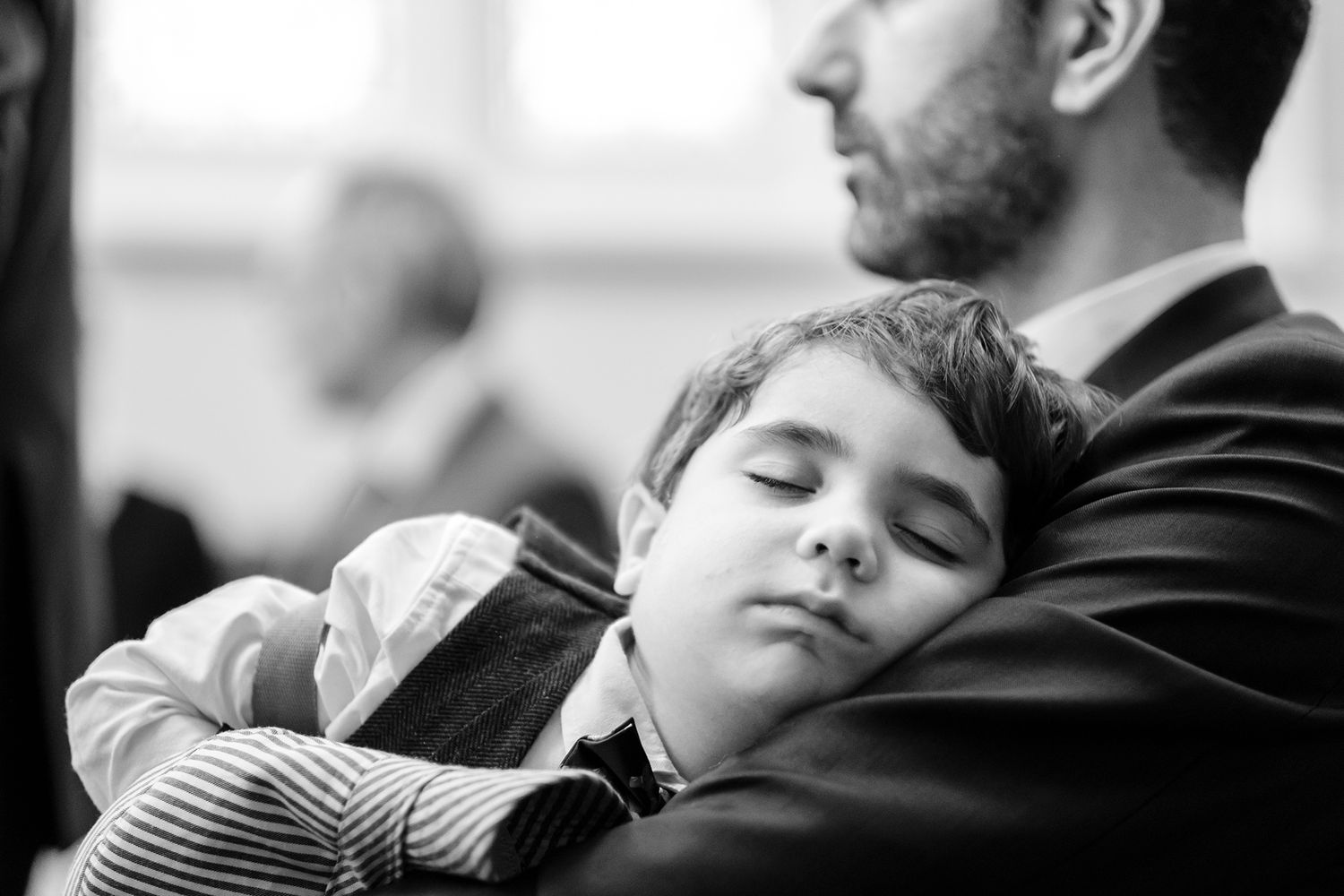Black and white candid portrait of child sleeping peacefully.