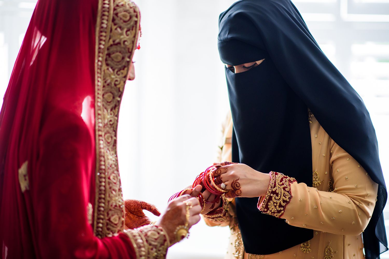 Traditional wedding preparations showing detailed henna designs and jewelry.