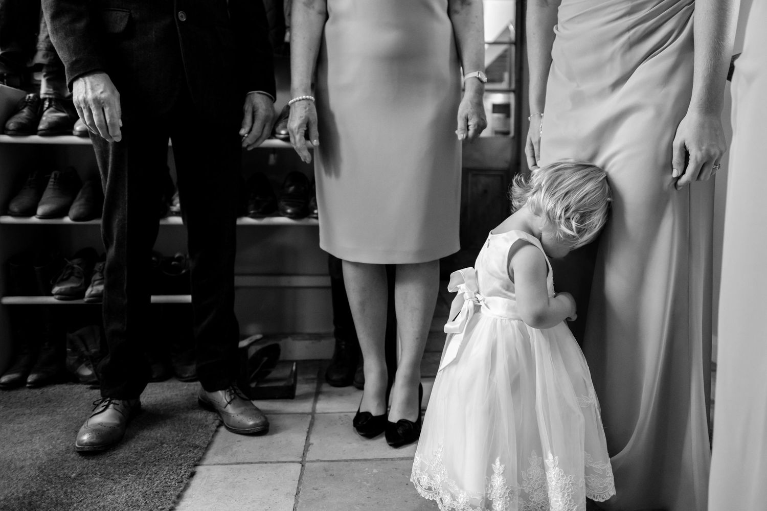 Wedding guests in formal attire gather at an elegant indoor reception venue.