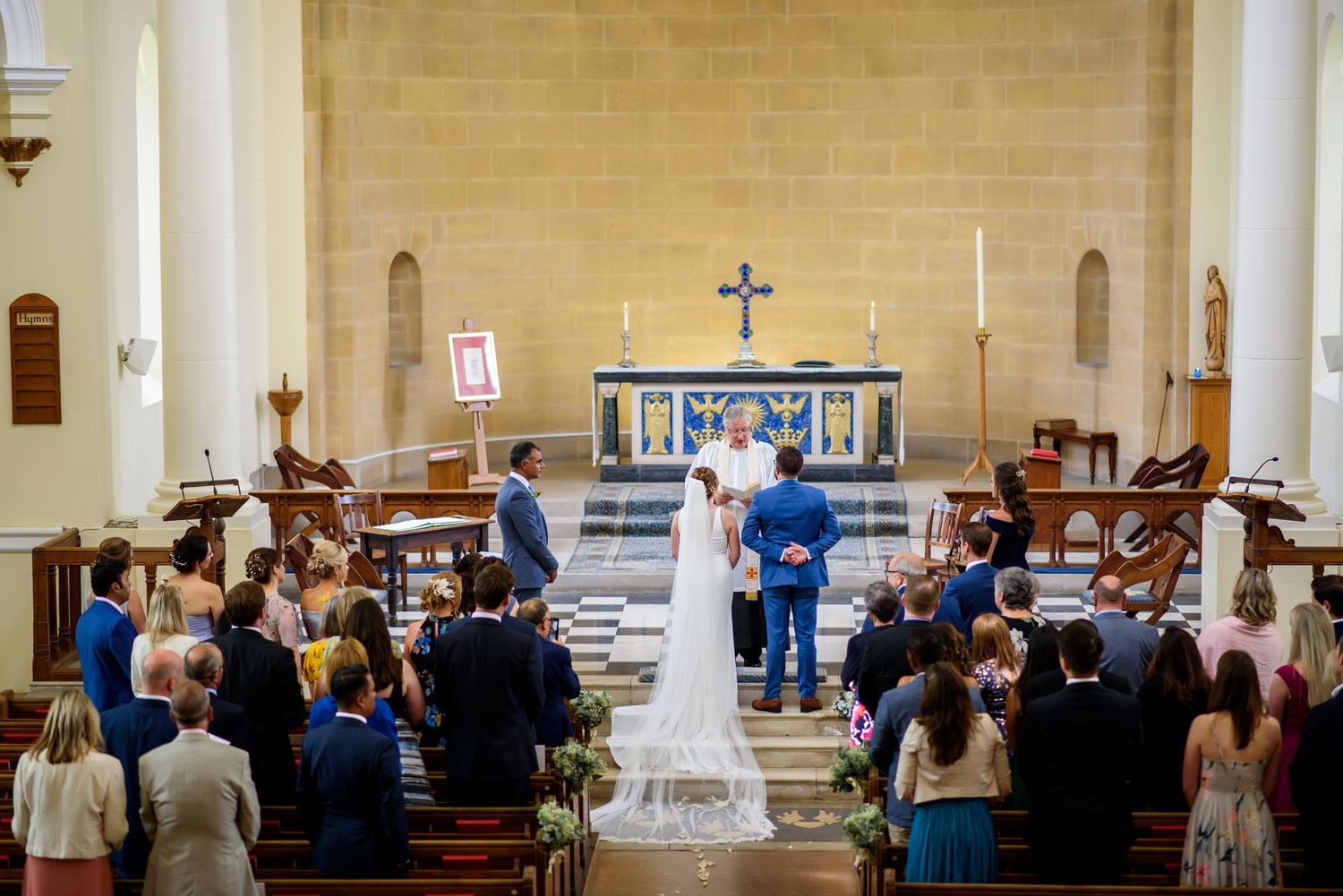 Interior view of a church sanctuary filled with wedding guests during the ceremony.
